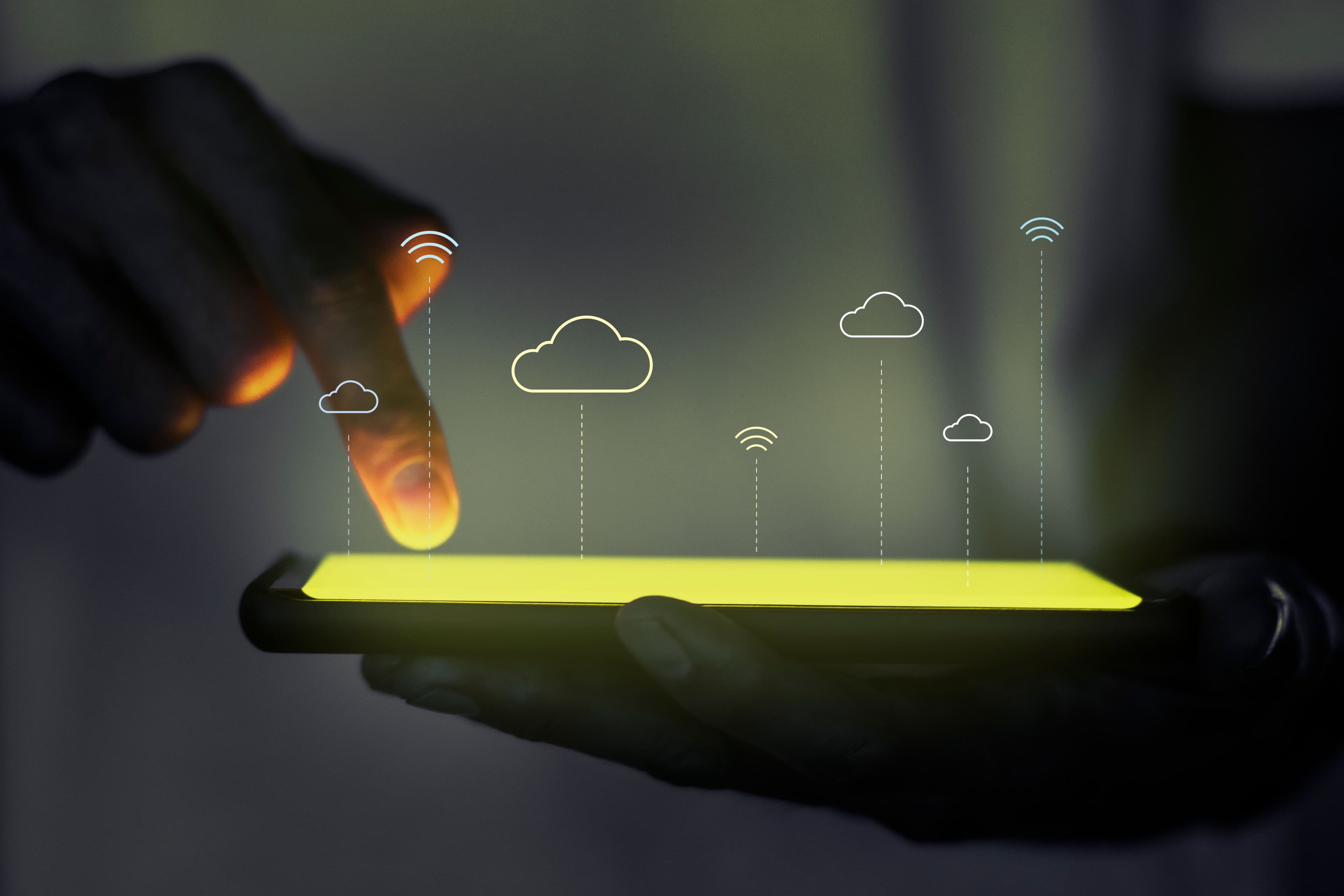 Finger interacting with a glowing device showing cloud icons, representing cloud infrastructure and DevOps engineering services.